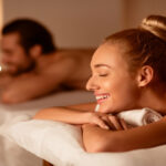 Spouses Receiving Relaxing Beauty Treatment Enjoying Aromatherapy Or Waiting For Exotic Back Massage Lying With Eyes Closed At Luxury Spa Center. Wellness And Body Relaxation. Selective Focus